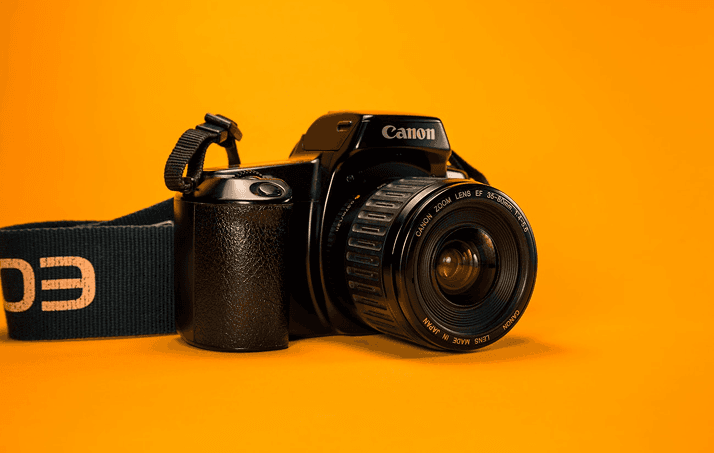 Canon camera on orange background